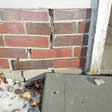 Crack running through brick foundation "Street Creep"
