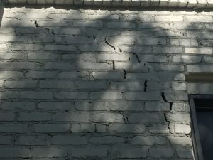 Exterior brick wall with large crack due to foundational settling
